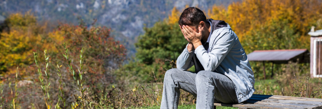 Person sitting with head in hands showing emotional distress and mental pressure, symbolizing anxiety, psychological stress, burnout, and difficult life situation.