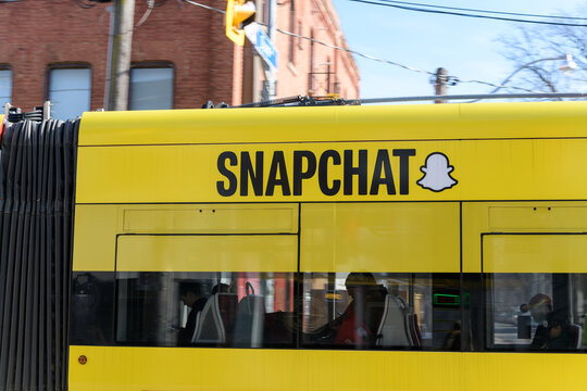 streetcar with Snapchat brand and "the ghost" logo advertising wrap in Toronto
