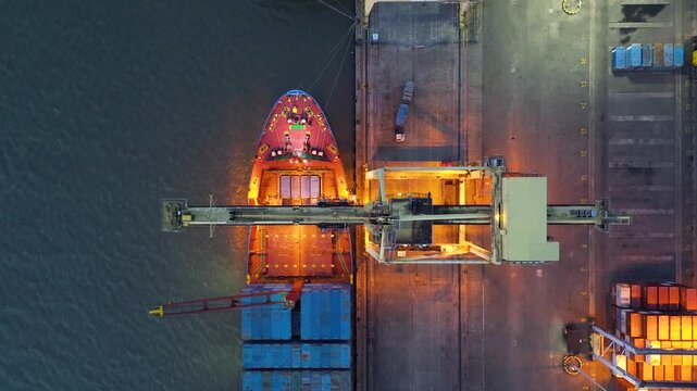 Container crane loading and unloading cargo at port terminal representing shipping logistics and cargo handling process