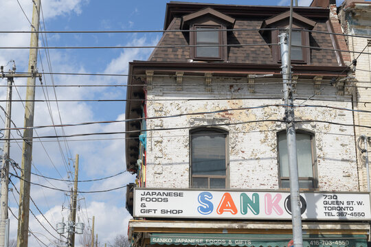 historic exterior and sign of Sanko Trading Co, a Japanese grocery store, located at 730 Queen St W, Toronto