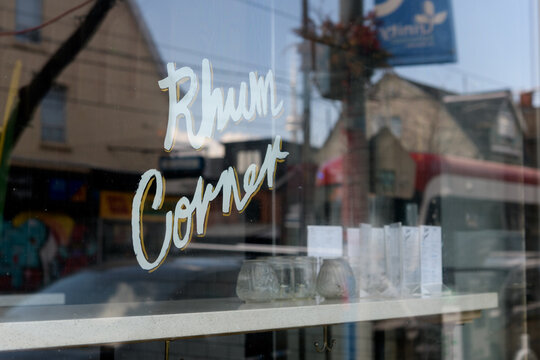 window sign of Rhum Corner, a restaurant, located at 926 Dundas St W, Toronto