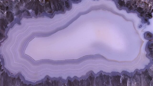 Abstract Purple Agate Slice &ndash; Organic Form and Delicate Patterns. A stunning macro shot captures the intricate beauty of a purple agate slice. The swirling, translucent bands of color.