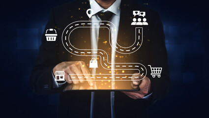 Fototapeta premium A businessman uses a tablet to visualize a digital journey with various business icons, symbolizing the connection between digital tools and customer engagement. Ledger