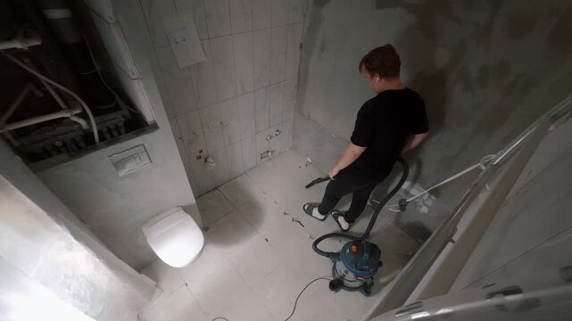 Man cleaning bathroom during renovation
