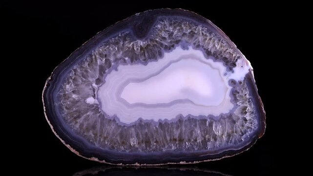 Macro Shot of a Stunning Agate Slice &ndash; Natural Mineral Beauty. A high-resolution macro showcasing a magnificent agate slice with intricate layers of purple, white, and grey.