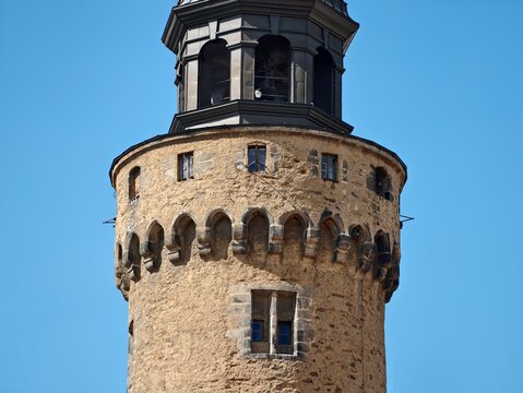 Stone fortress under bright day. Photograph capturing weathered tower with detailed architecture