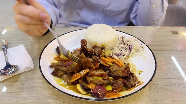 Trying local Asian street food.Tourist man eating asian food street local cafe