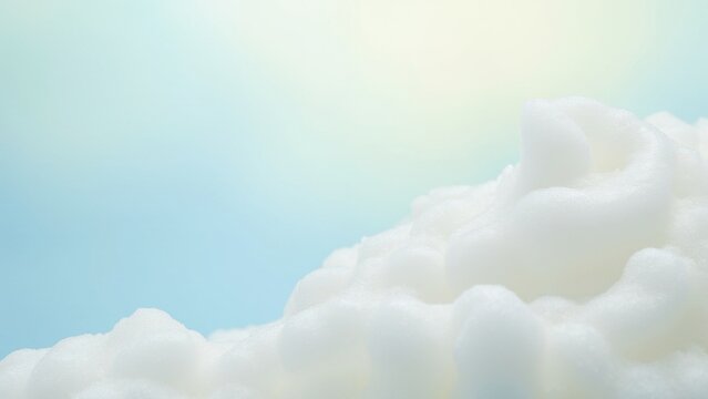 An airplane flying through a fluffy white cloud on a clear day.