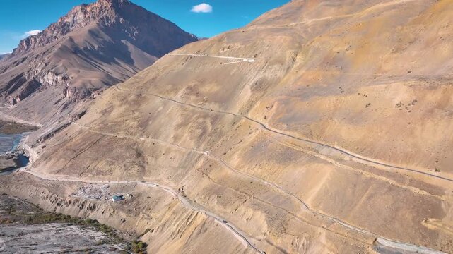 Aerial view of the steep, zigzagging mountain road from Kaza to Langza in Spiti Valley.