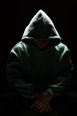 Man in stylish hoodie on black background