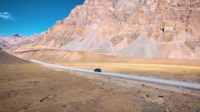 SUV, 4x4, off-road, dirt road, driving, vehicle, car, tracking shot, road trip, adventure, freedom, isolation, solo travel, epic, cinematic, scale, vast, barren, cold desert, Himalayas, Spiti Valley, 