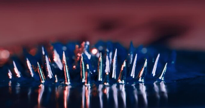 This captivating visualization shows how metal particles form intricate shapes under magnetic forces, set against a dramatic black background that enhances various creative projects
