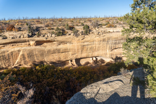 Fire Temple and New Fire House at Mesa Verde National Park in Colorado. Protected Ancestral Puebloan sites, famous cliff dwellings. Shadow of modern visitor. 