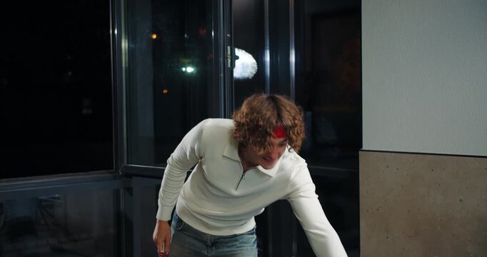 Man playing table tennis preparing forehand shot indoors