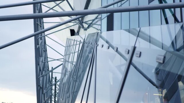 Glass and metal frame composition decorates skyscraper facade low angle shot. Elegant architectural stye of modern downtown district