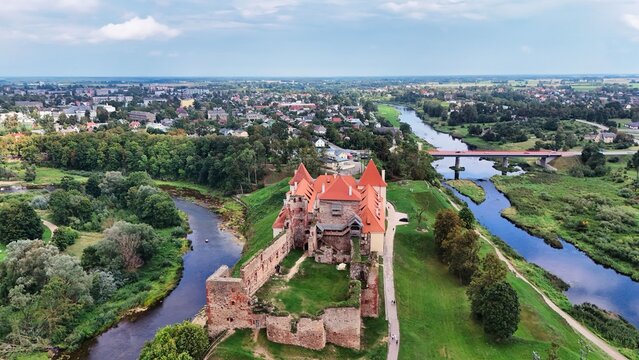 Drone View of Bauska Castle and Scenic River Confluence in Latvia