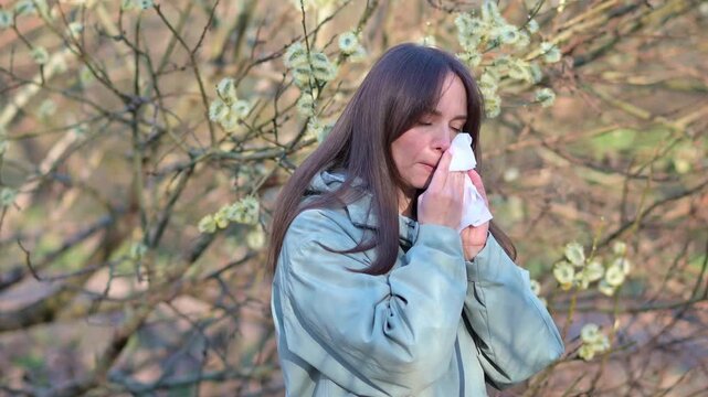 Woman Sneezing Blowing Nose and Wiping Itchy Eyes in Spring Forest Seasonal Pollen Allergy Symptoms