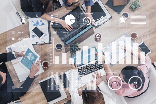 A dynamic business meeting scene showcasing professionals analyzing data through graphs and reports on laptops. Collaboration drives strategy and insights. Impute