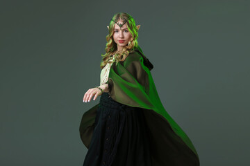 Naklejka premium Beautiful girl dressed as elf on grey background