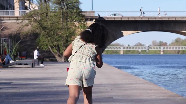 Young girl walking on the river embankment in roanne