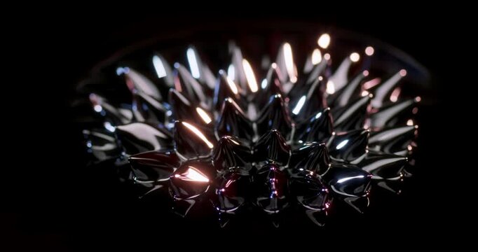 A breathtaking closeup view of ferrofluid exhibiting dynamic and mesmerizing abstract shapes against a captivating dark background, perfect for innovative motion graphics and various design projects