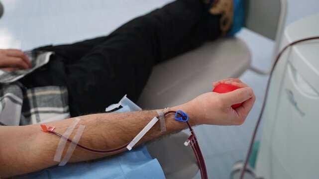 Male patient donating blood in a hospital clinic