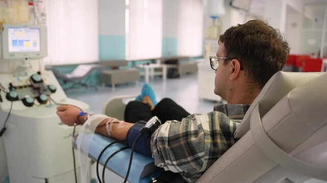 Male volunteer patient donating rare blood in a hospital transfusion center