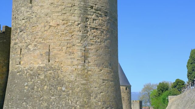 Medieval stone tower with battlements under clear blue sky