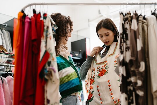Friends enjoying fashion shopping, choosing new clothes