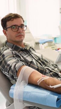 Male volunteer donating blood at hospital center