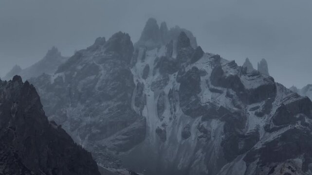 Aerial footage of beautiful high altitude snowcapped mountains and forest landscape