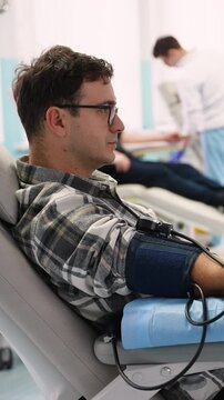 Male volunteer patient donating rare blood in a hospital transfusion center