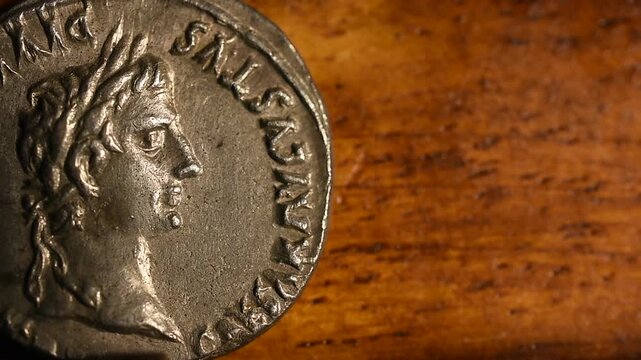 Roman Silver Coin Denarius on an old wooden background 