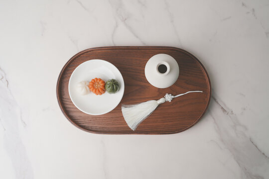 Korean Traditional Dessert Dasik on a White Plate, Minimal Flat Lay with Wooden Tray and Ceramic Vase