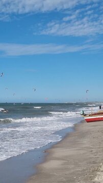 Kitesurfing and Traditional Fishing Boat on Prea Beach under Blue Sky. Ceara, Brazil