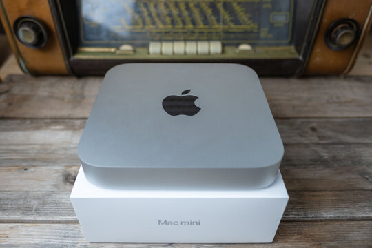 new Apple Mac Mini M1 computer held Unboxing, technology portability, working remotely in cozy home environment, embracing comfortable downshifting lifestyle, Frankfurt - February 4, 2025
