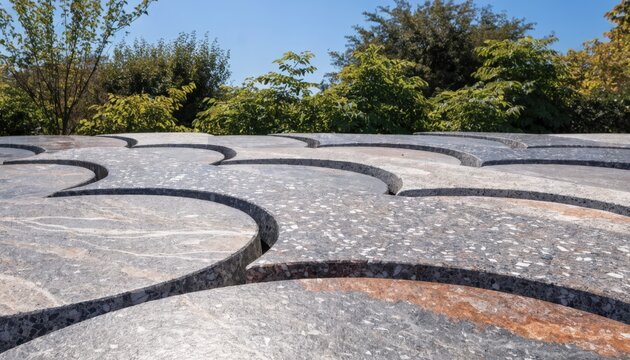 Medium shot of sintered stone slabs arranged in a driveway pattern showcasing their robust composition and smooth finish under natural light.