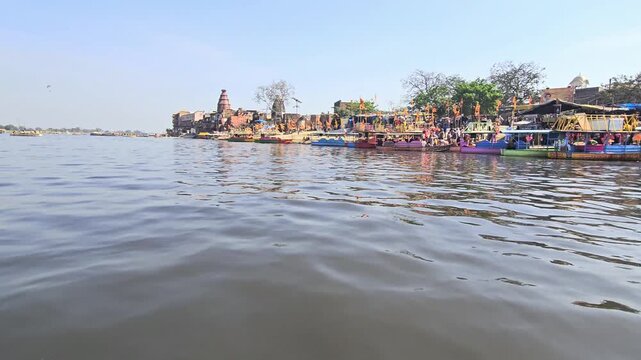 Scenic view of Kaliya Ghat (Kalideh) in Vrindavan from the Yamuna River, showcasing historic temples, ghats, and traditional architecture. This sacred location is associated with Lord Krishna