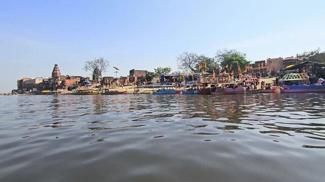 Scenic view of Kaliya Ghat (Kalideh) in Vrindavan from the Yamuna River, showcasing historic temples, ghats, and traditional architecture. This sacred location is associated with Lord Krishna