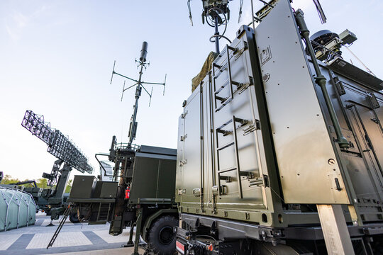 Military equipment and army equipment.. Sunset displays mobile units equipped with radar and support gear. Nighttime highlights various support vehicles operationally equipped