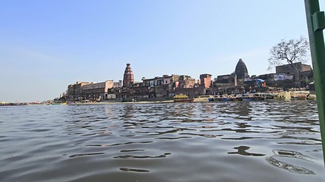 Scenic view of Kaliya Ghat (Kalideh) in Vrindavan from the Yamuna River, showcasing historic temples, ghats, and traditional architecture. This sacred location is associated with Lord Krishna