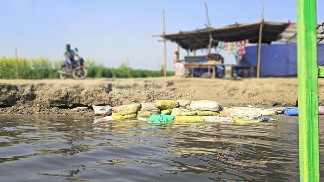 Scenic view of Kaliya Ghat (Kalideh) in Vrindavan from the Yamuna River, showcasing historic temples, ghats, and traditional architecture. This sacred location is associated with Lord Krishna
