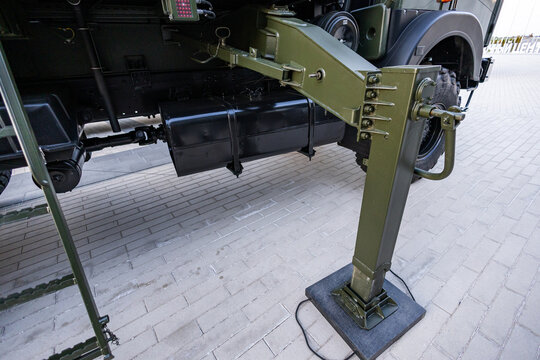 Military equipment and army equipment.. Ensuring stability and safety during hydraulic equipment installation. Implementing effective safety measures with stabilizers and load distribution