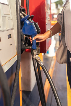 Hand pumping fuel facing high energy costs