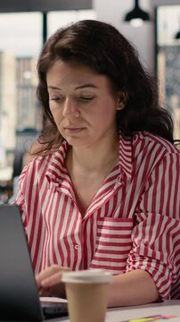 Vertical Video Portrait of businesswoman inside open space office environment, creative agency staff planning strategy for development and management. Employee consultant in smart office corporation.