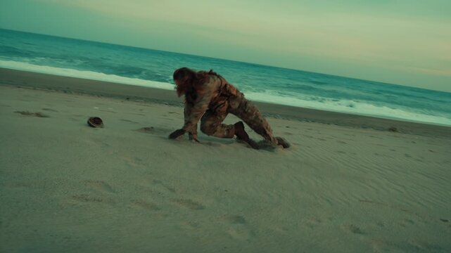 American soldier runs and somersaults on the beach near the ocean in the morning