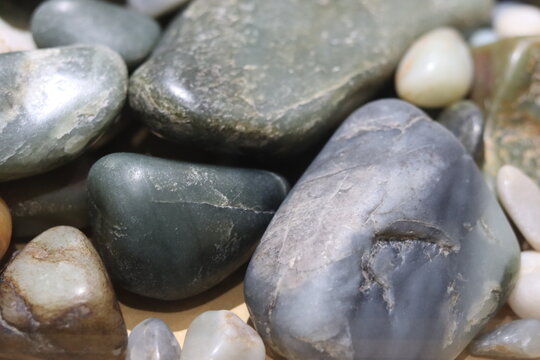 Close-up of nephrite jade rocks with different colors. Geologic formation and mineralogy. Greens stones.