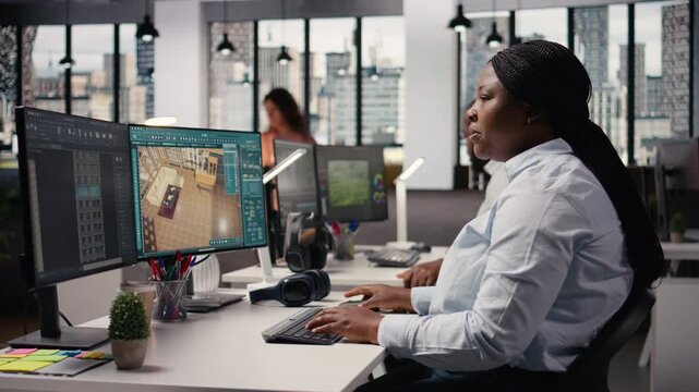 African american developers team using architectural software on computer, working on interior design and new apartment floor plan. Man and woman works with remodeling tools for 3D visuals.