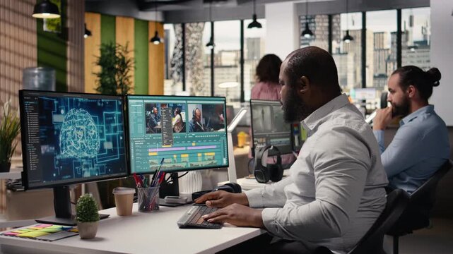 Video editor cutting raw film footage with advanced AI software on PC, working in modern studio office. Creative process shows color grading and motion graphics tools powered by machine learning.