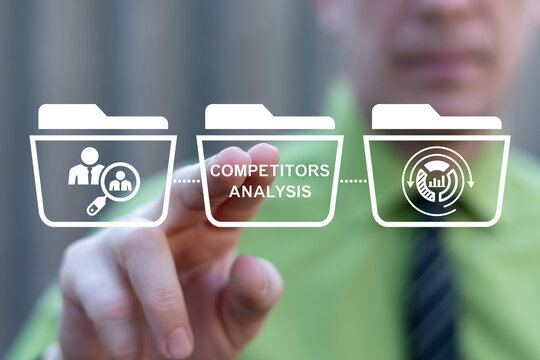 Concept for competitor and market analysis, consumers. Business person using virtual touch screen presses the text COMPETITORS ANALYSIS.
